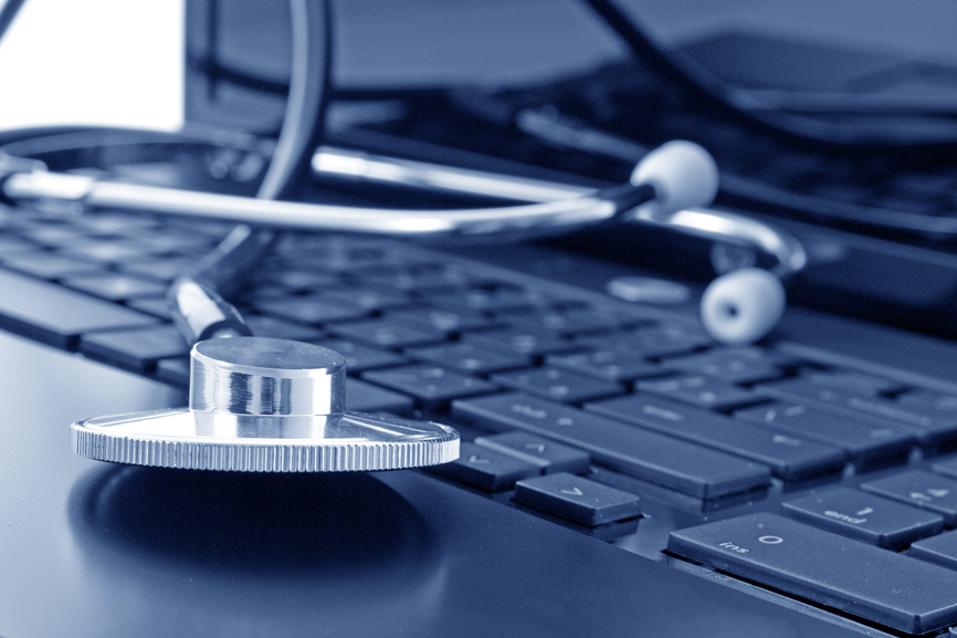 Doctor stethoscope on the laptop keyboard, image in blue tone
