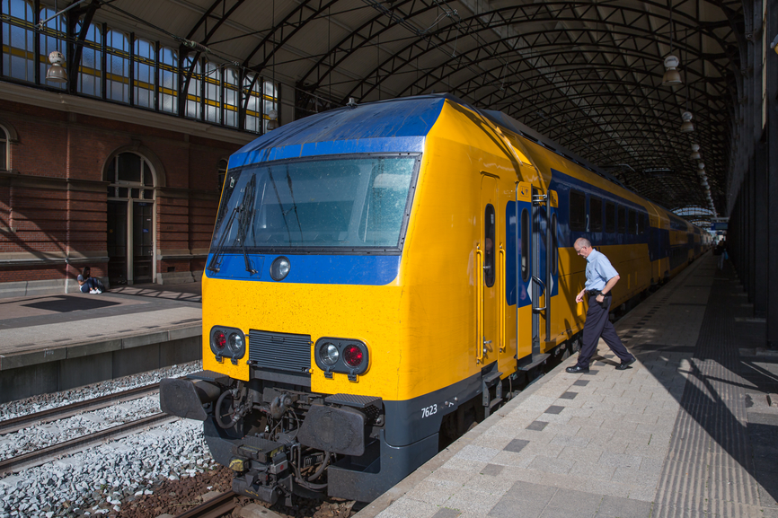 Conductor getting in a train ready to start in The Hague, the Netherlands