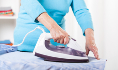 Elderly lady during ironing