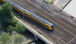 Aerial view of Dutch train at a bridge crossing a canal