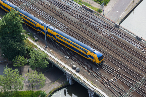 Aerial view of Dutch train at a bridge crossing a canal