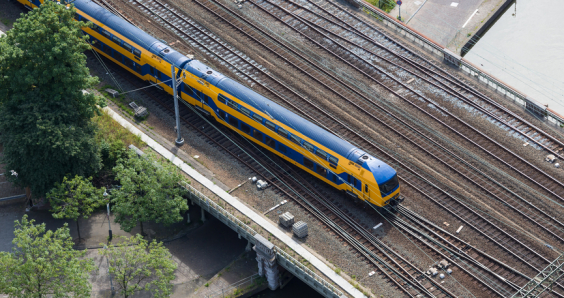 Aerial view of Dutch train at a bridge crossing a canal