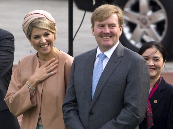 Netherlands' King Willem-Alexander and his wife Queen Maxima smile as they attend a soccer training lesson at Shijia Primary School in Beijing