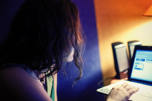 Women with laptop working in the dark