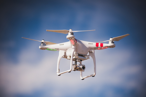 flying drone with camera on blue the sky