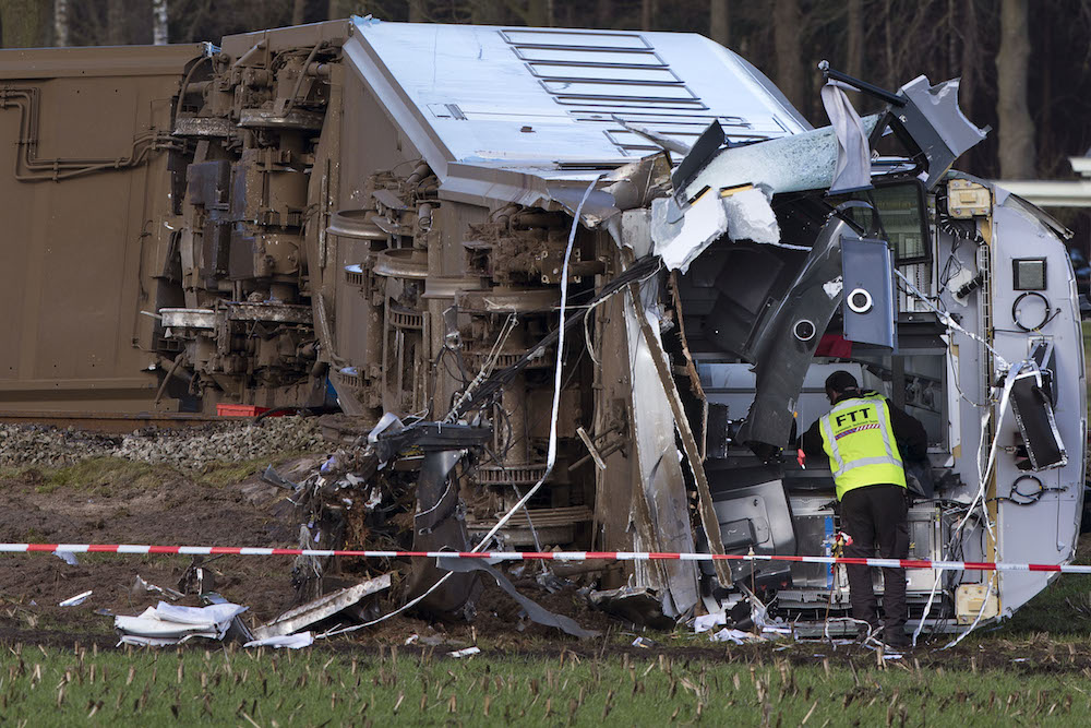 Emergency services look for evidence at the wreck of commuter train which derailed near Dalfsen. Photo: AP/Peter Dejong