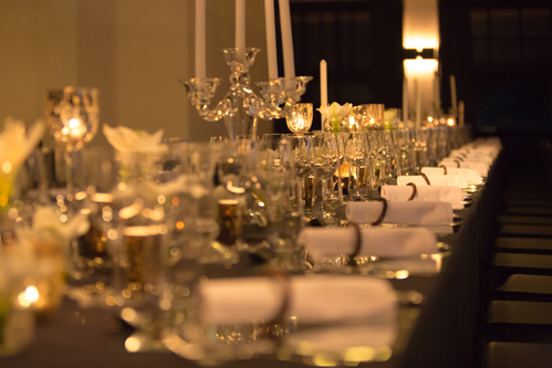 Christmas table setting, retro style photo, glasses for champagne, white festive dishware, soft focus.