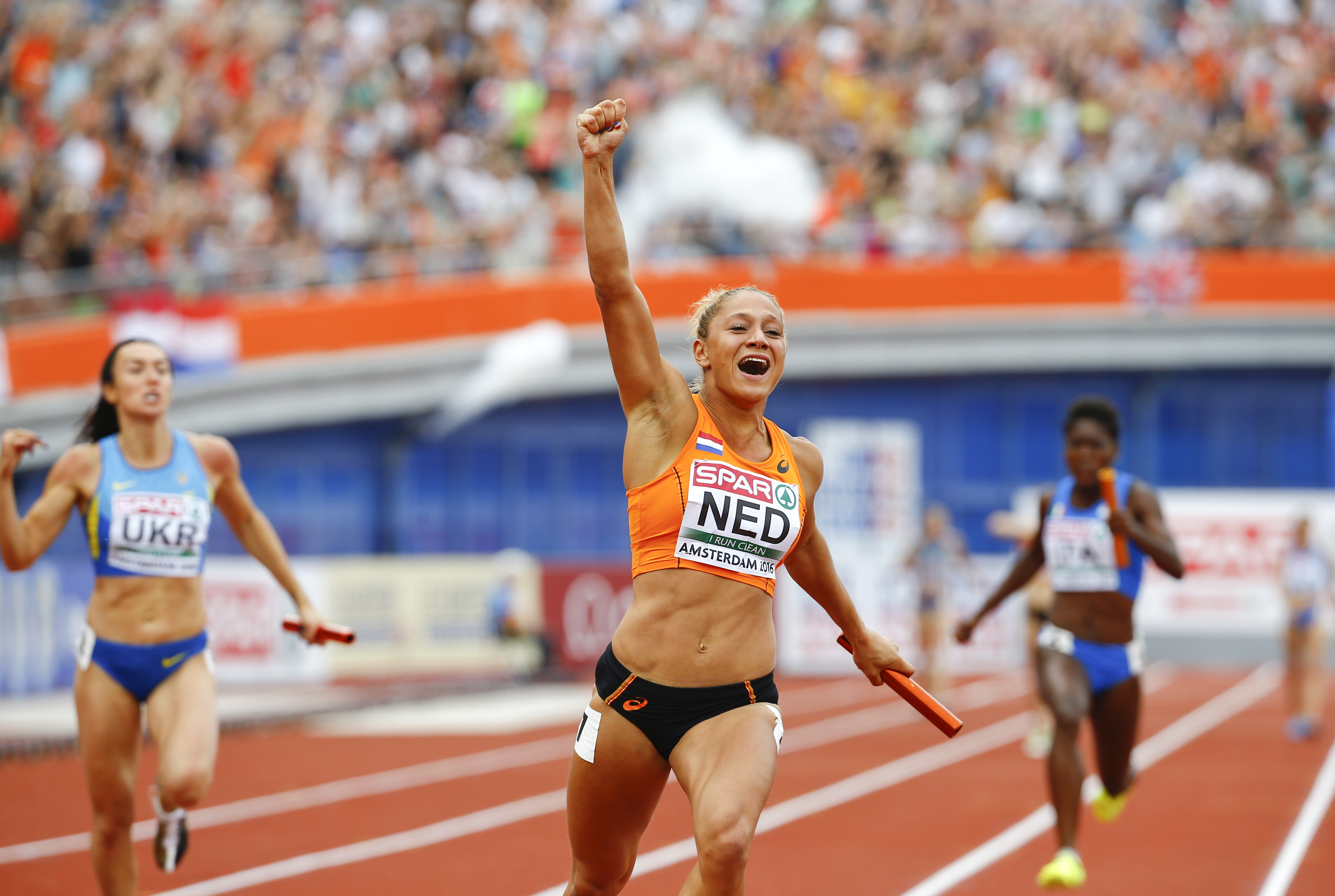 A triumphant Naomi Sedney crosses the finish as the Netherlands takes the 4x100m relay title. Photo: Reuters 