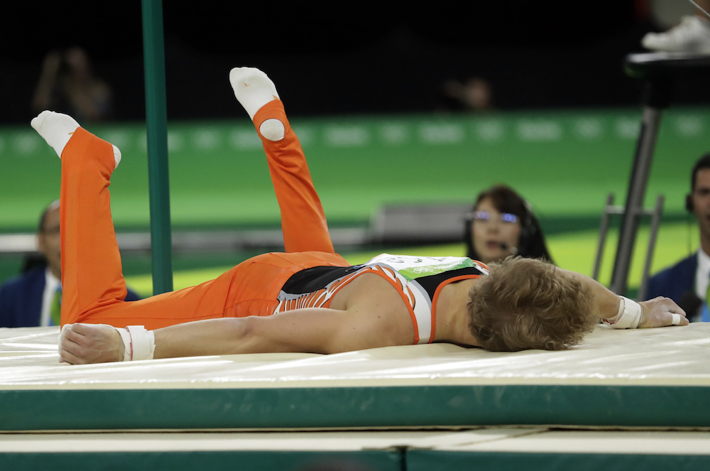 Epke Zonderland lies on the mat after falling from the bar. Photo: AP Photo/Dmitri Lovetsky