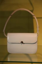 A white leather handbag worn by Britain's Queen Elizabeth.