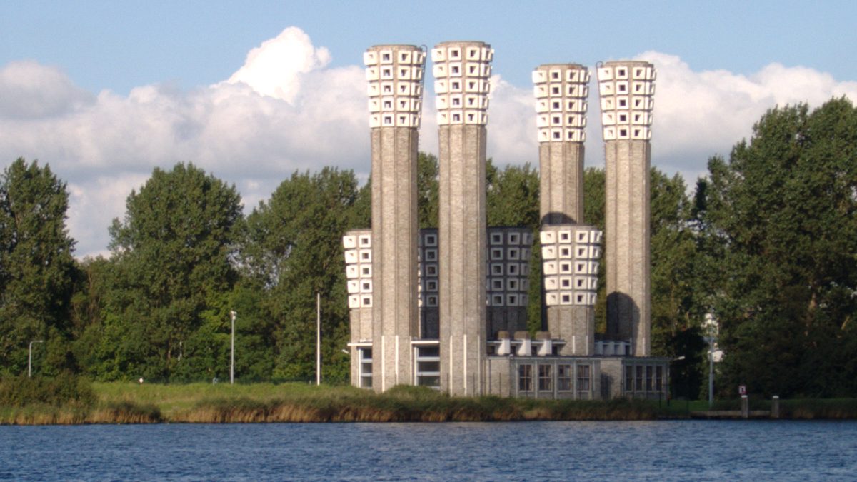 The grey concrete ventilation towers for the Velsertunnel on the north bank of the IJ in the Netherlands. 