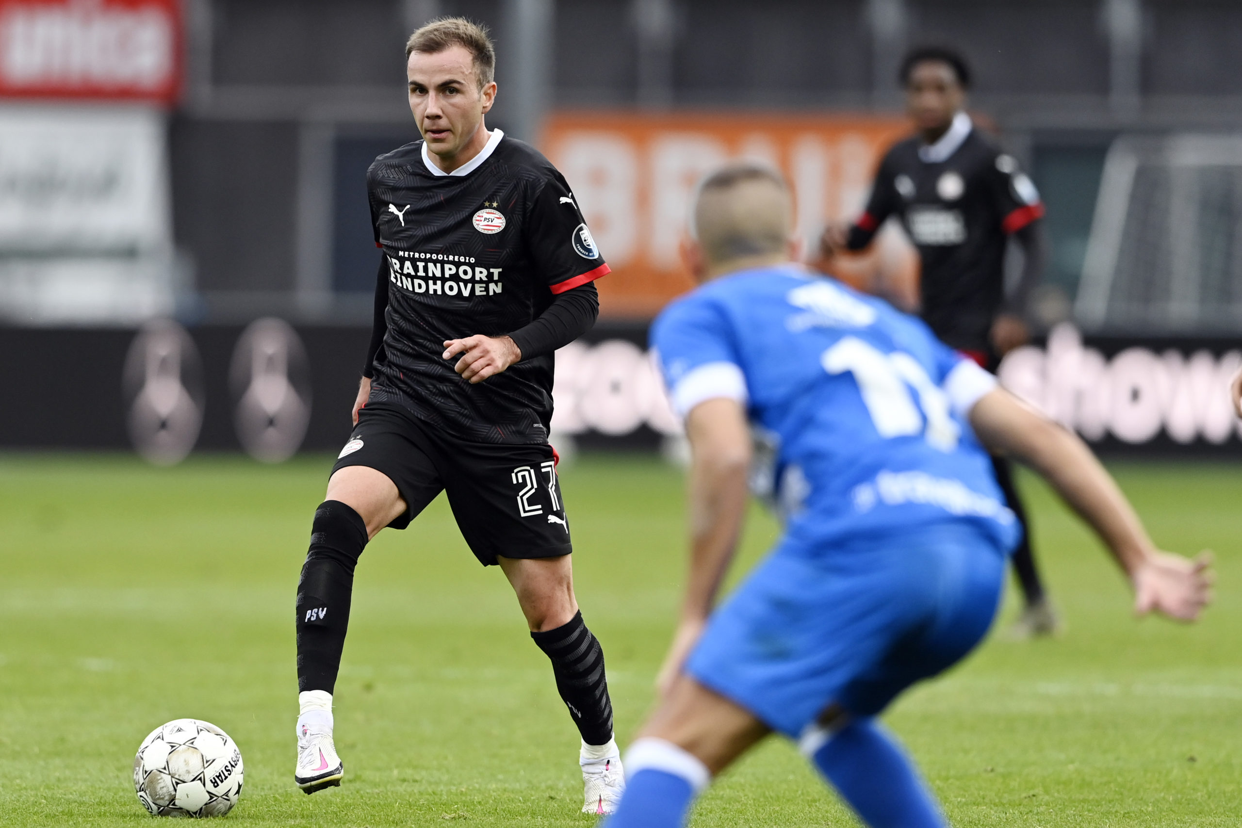 Mario Götze with the ball for PSV EIndhoven against an unidentified PEC Zwolle defender
