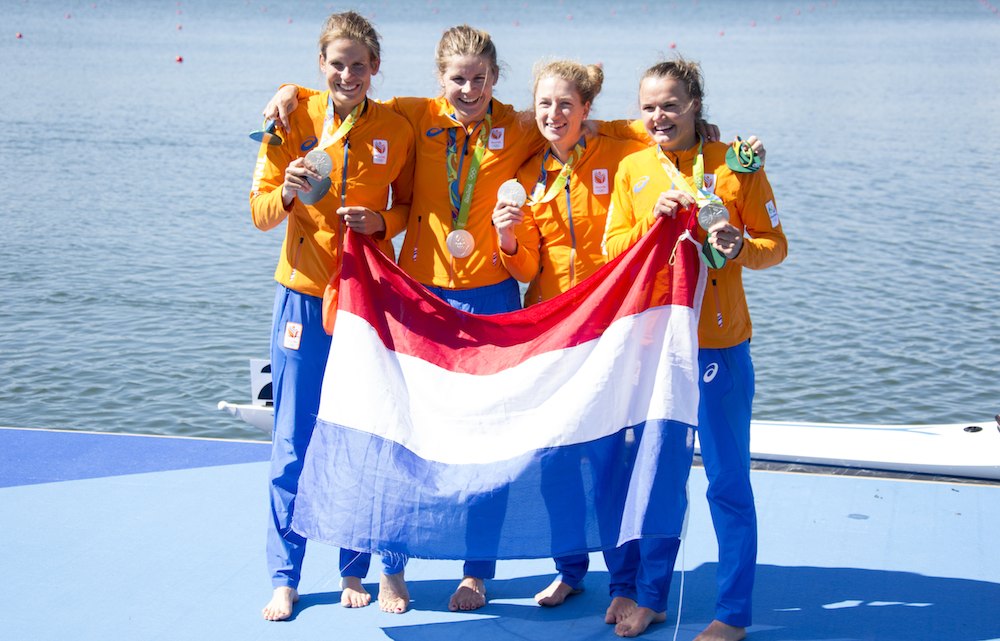 The Dutch quad sculls team show of their medals. Photo: Wieringa Photography via HH