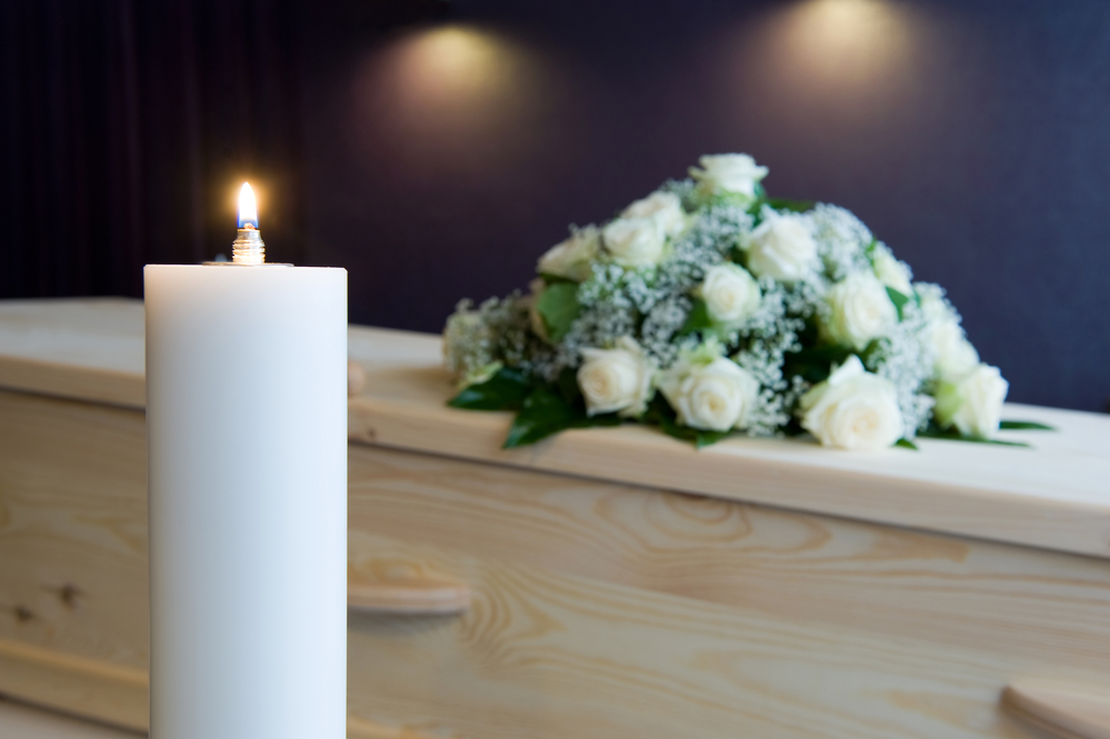 Burning candle in mortuary funeral death