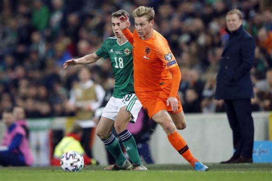 Frenkie de Jong and Gavin Whyte jostling for possession