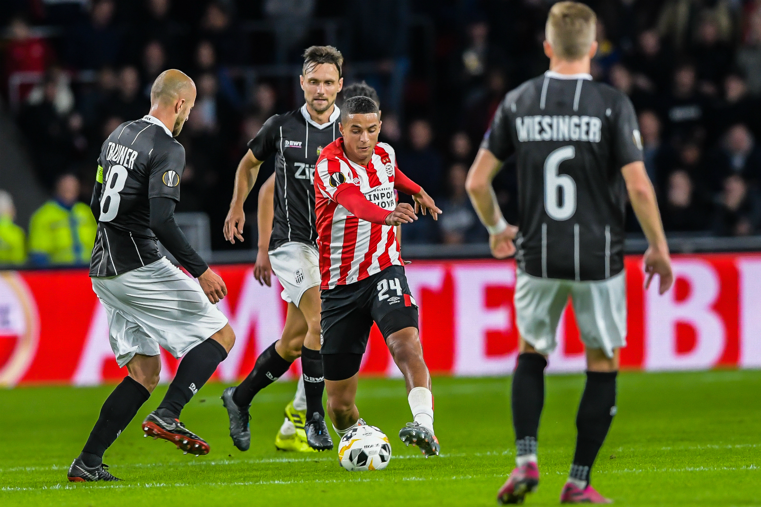 PSV midfielder Mohamed Ihattaren on the ball surrounded by defenders during a match against LASK Linz of Austria.