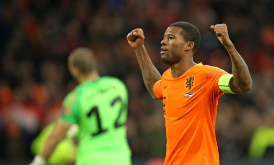 Georginio Wijnaldum celebrating one of his three goals with his arms aloft.