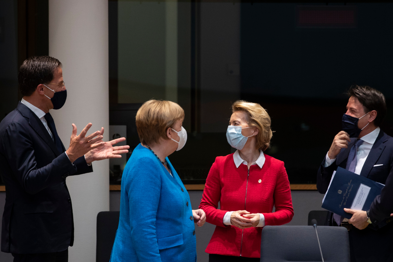 Mark Rutte holding his hands outstretched, with Angela Merkel, Ursula von der Leyden and Giuseppe Conte looking on at the EU budget summit in Brussels.
