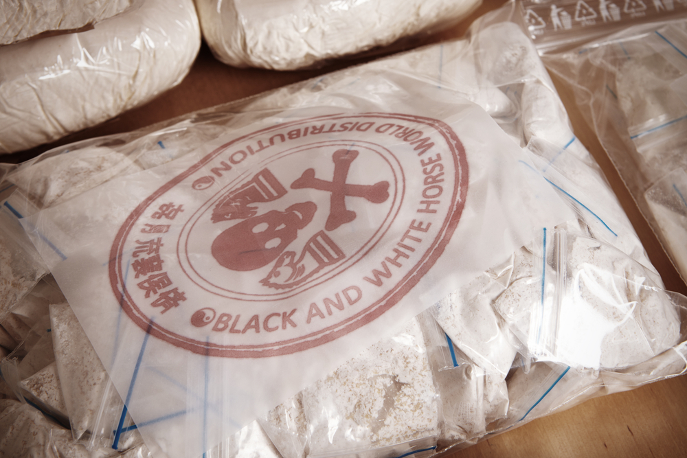 A big bag of illegal drugs with a death's head logo