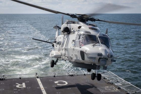 An NH-90 helicopter landing on an aircraft carrier