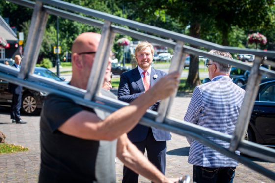 King Willem-Alexander photographed through the rungs of Herman Dinius's ladder.