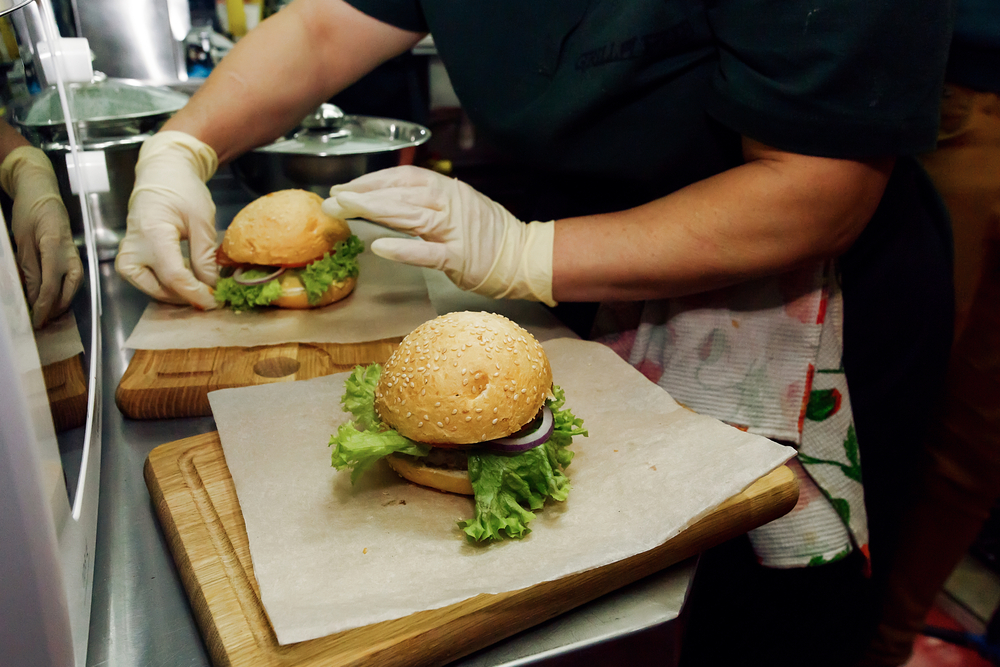 Close-up shot of a chef preparing a hamburger