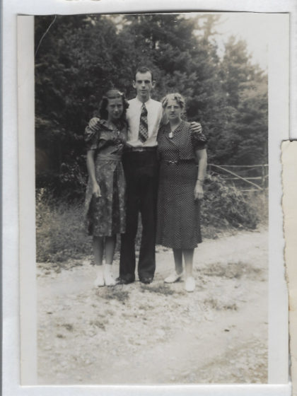 Black and white photograph of Harry Farrington flanked by his sister, Edith, and mother, Bertha.