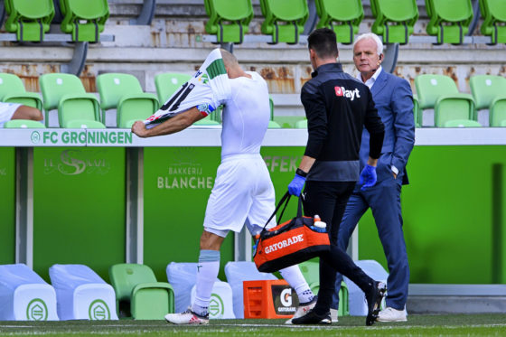 Arjen Robben leaving the field with his shirt pulled over his head.