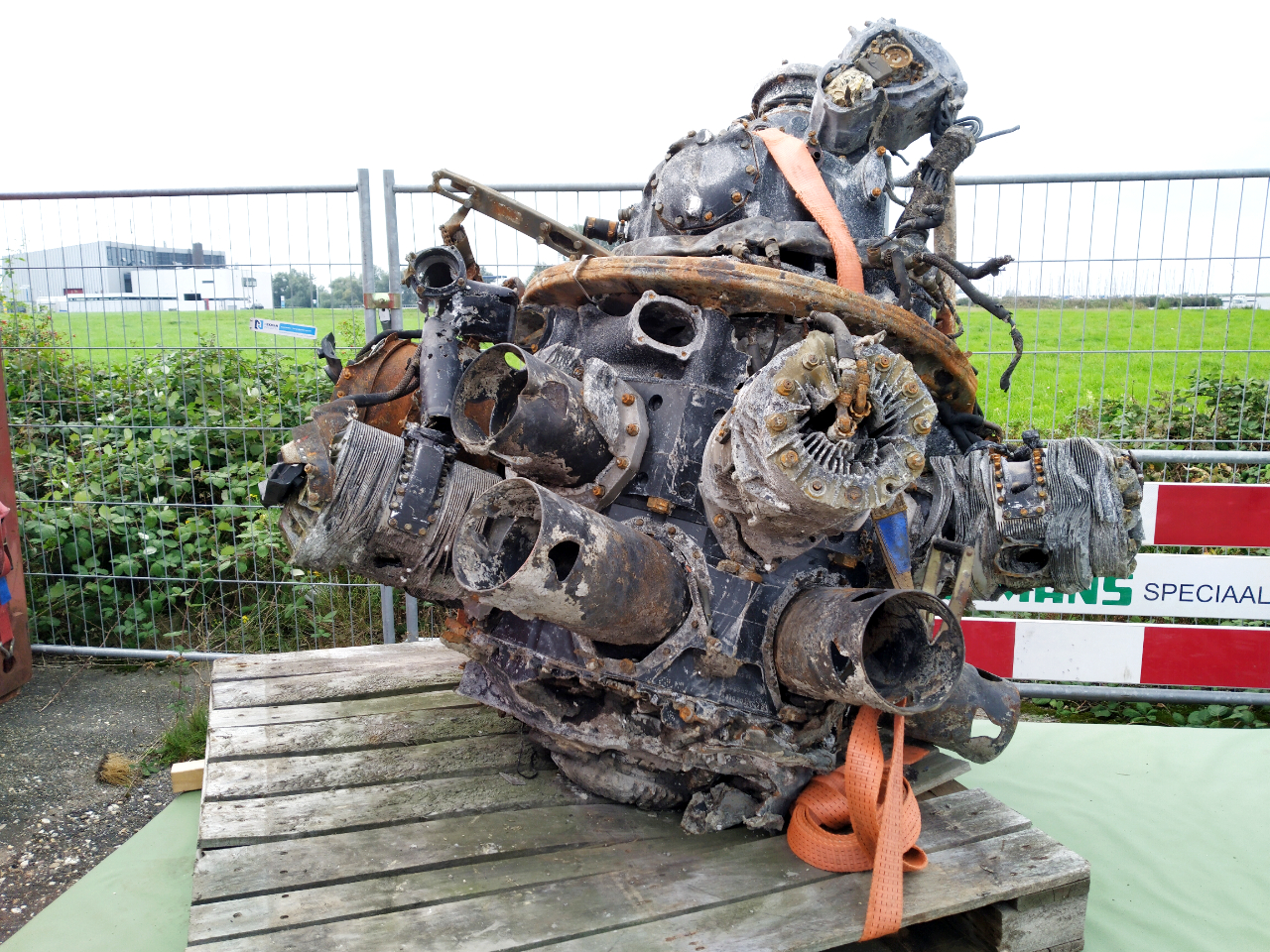 The mangled wreckage of the engine of the BK716 presented on a table at the recovery site.