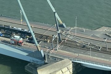 An overhead view of the bridge with the cable support lying on the ground at one end.