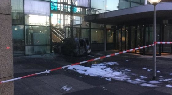 The burned-out Volkswagen Caddy van in the entrance to the Telegraaf building, cordoned off by red and white police tape.