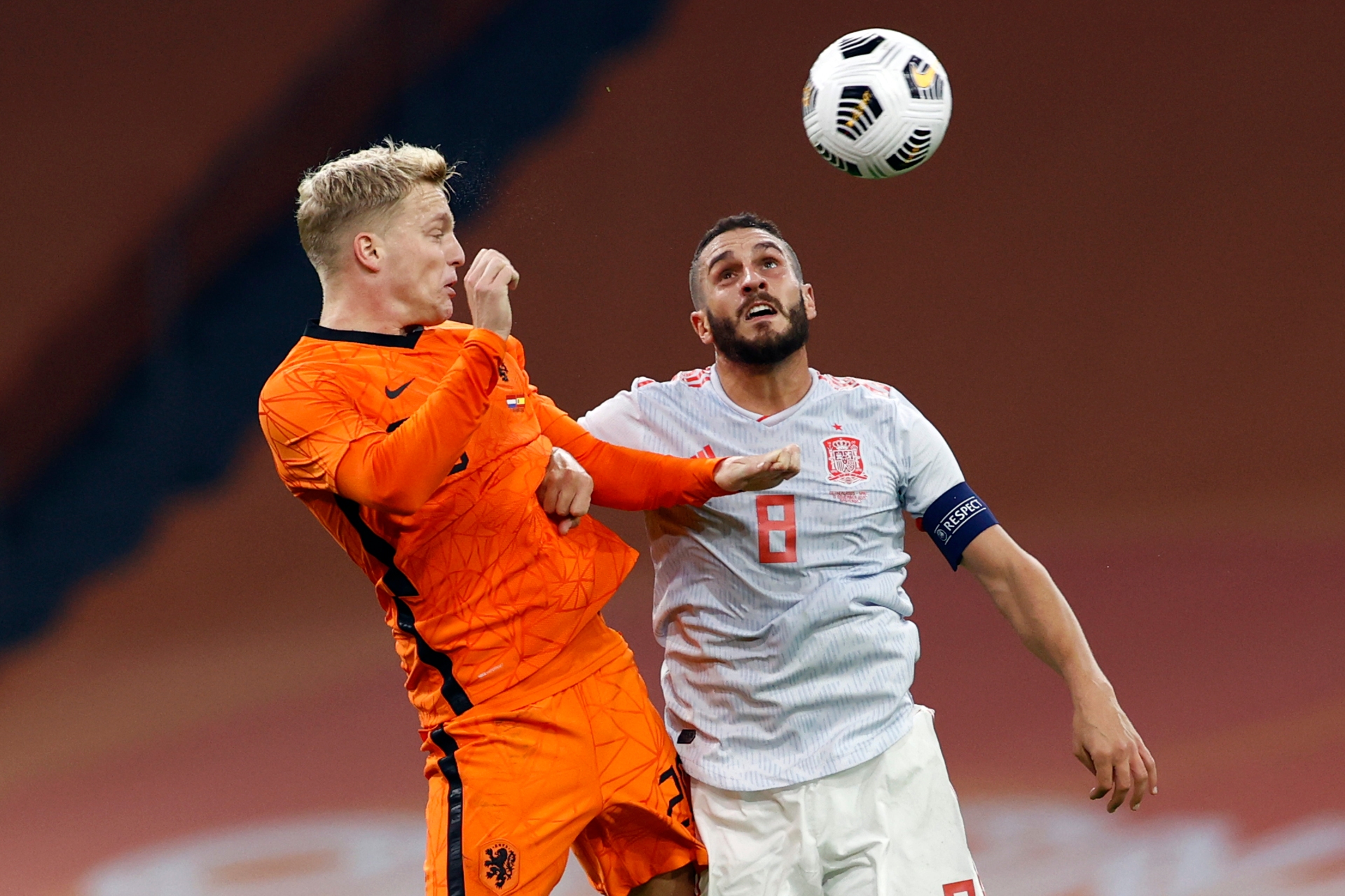 Donny van de Beek in orange rising to head the ball