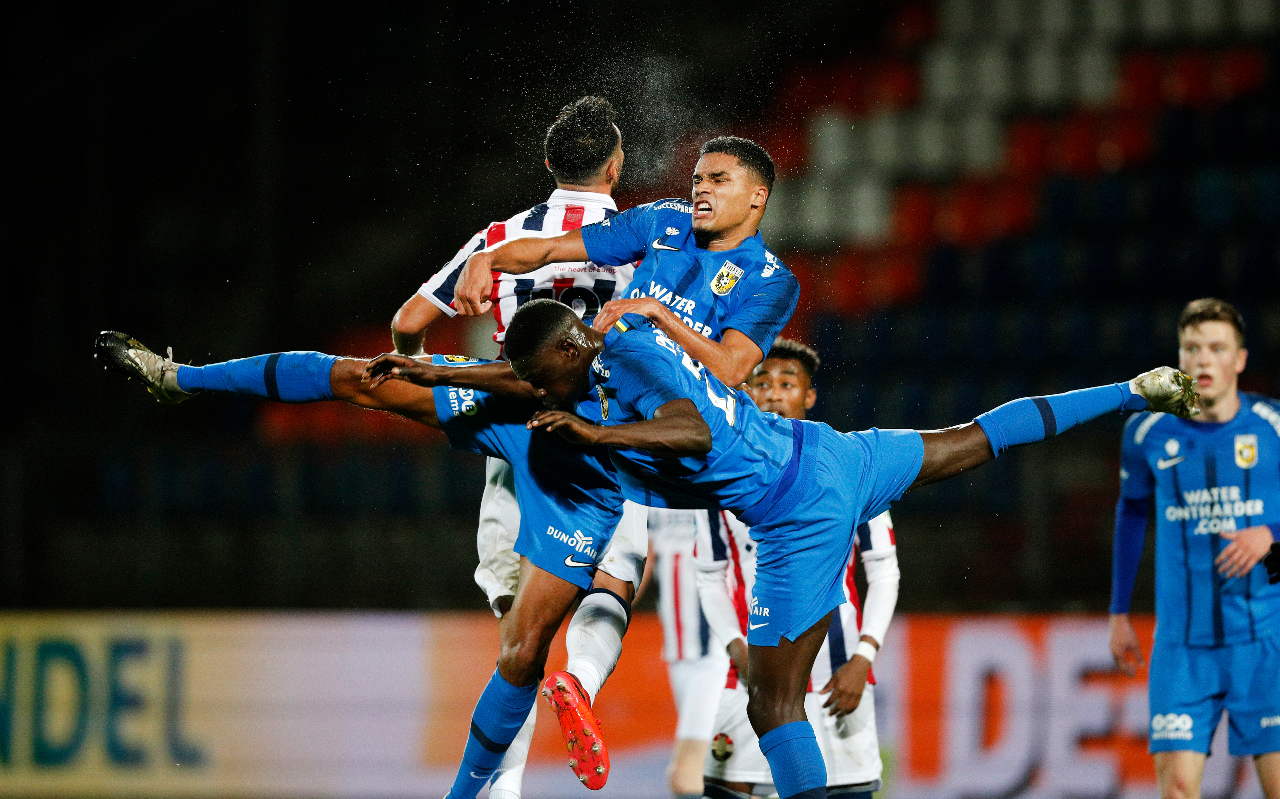 Danilho Doekhi and Idrissa Toure of Vitesse Arnhem, playing in blue, tangle for the ball during the 3-1 win over Willem II in Tilburg.