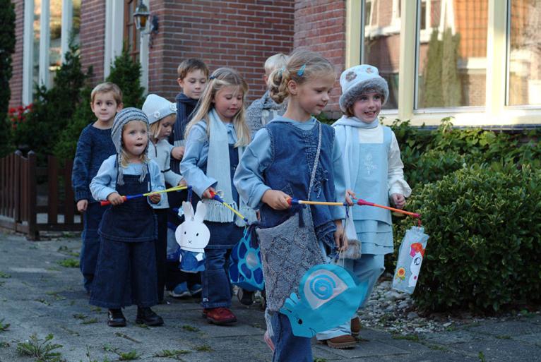 Children going door to door with paper lanterns during the traditional Sint-Maarten festivities