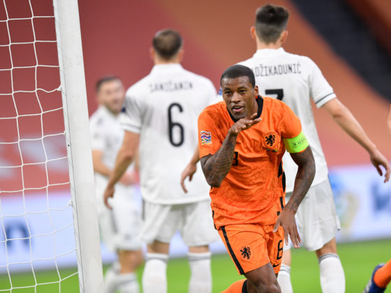 Georginio Wijnaldum smiles and points in celebration after scoring his second goal